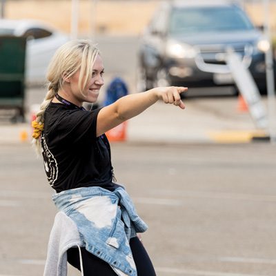 picture of blonde student pointing happily