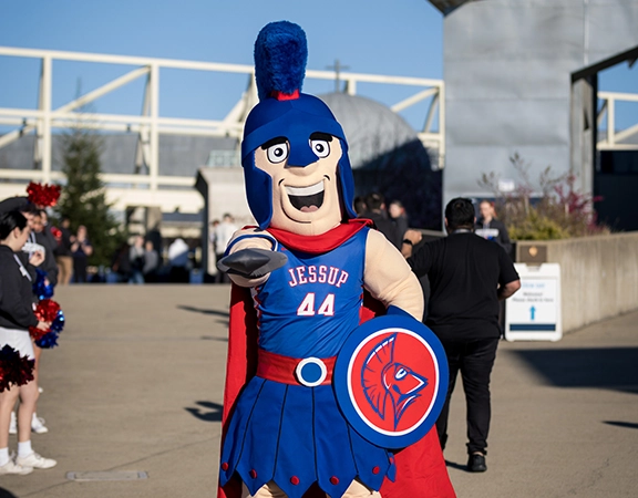 Willy the Warrior, the Jessup Mascot, pointing at the camera and smiling.